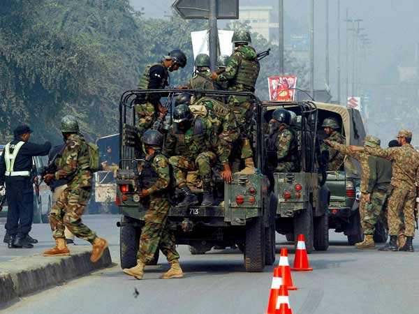 A hospital security guard helps a student injured in the shootout at a school under attack by Taliban gunmen A hospital security guard helps a student injured in the shootout at a school under attack by Taliban gunmen