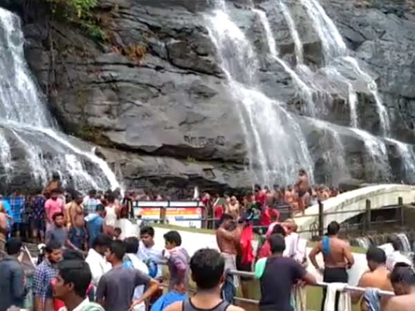 Tourists throng Courtallam for take a bath in falls