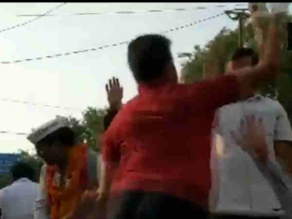 A man slaps Delhi Chief Minister Arvind Kejriwal during his roadshow 