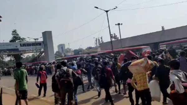 Migrant workers rush towards Majestic bus stand in Bengaluru 