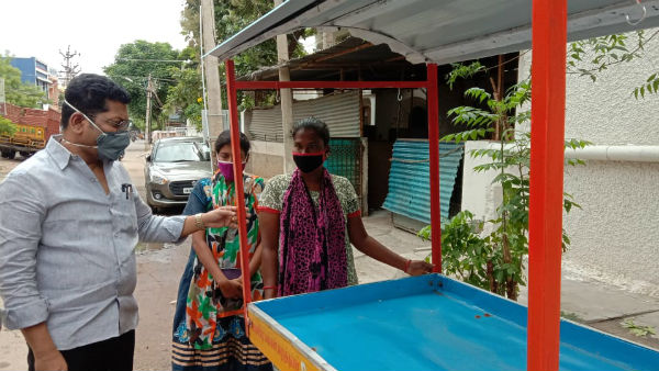 DMK MLA Dr Saravanan helps set up a shop for a woman selling tea