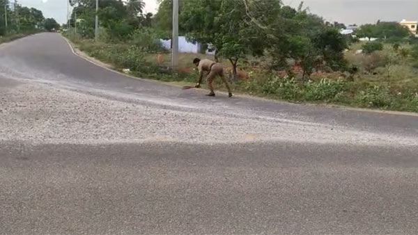 head Constable Jagadeesh sweeping Gravel scattered on road near Panakudi in Nellai 