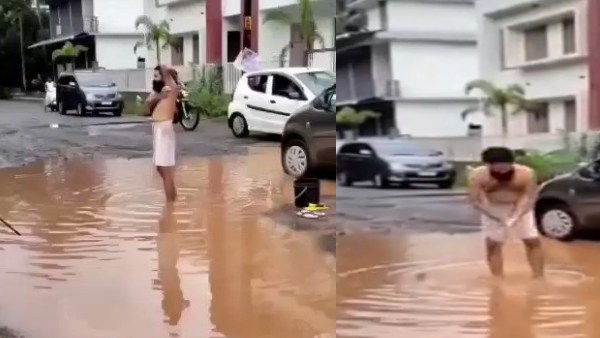 A pothole in the road; The young man complained to the MLA after bathing in stagnant rain water A pothole in the road; The young man complained to the MLA after bathing in stagnant rain water