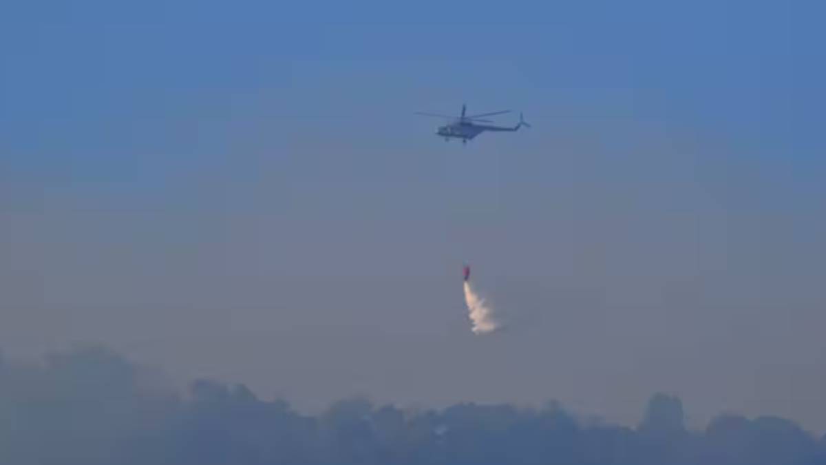 Helicopter using to doused Western Ghats Forest fire near by Madhukkarai in Coimbatore 