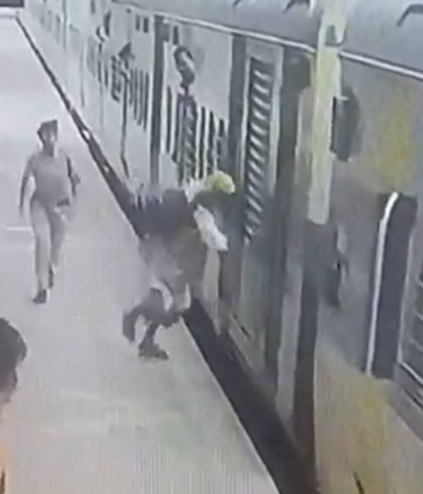  RPF woman officer saving a passenger from falling under a moving train 