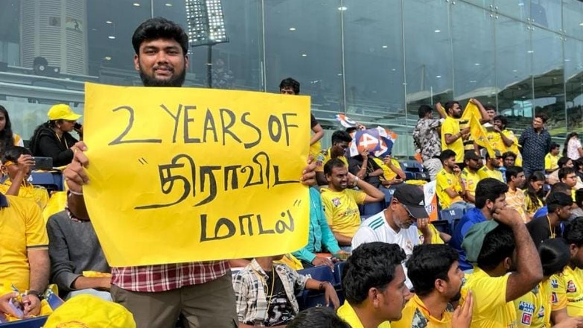 CSK fan carried a banner reading 2 Years of Dravidian Model CSK fan carried a banner reading 2 Years of Dravidian Model