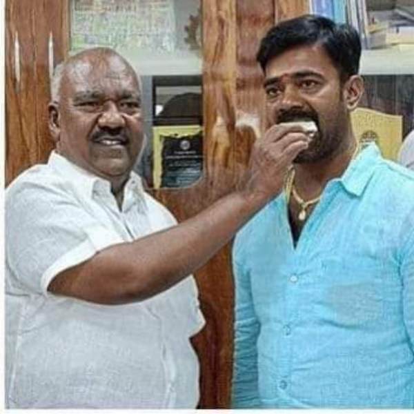 Minister masthan explains about illicit liquor trader take photo with him 