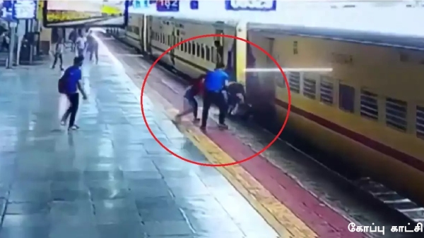 An RPF cop saved a woman who fell while trying to board a running train at Chennai Central Railway Station An RPF cop saved a woman who fell while trying to board a running train at Chennai Central Railway Station