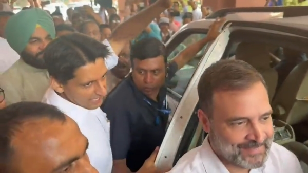 Rahul gandhi return back to Parliament Lok Sabha with white shirt 