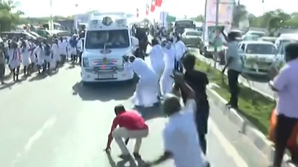 AIADMK cadres fall before the van in which Edappadi Palanisamy travelling AIADMK cadres fall before the van in which Edappadi Palanisamy travelling