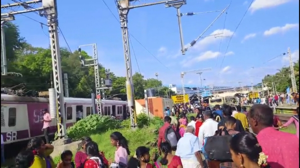 Passenger running away after smoke from an electric train at Chennai Guindy Railway Station Passenger running away after smoke from an electric train at Chennai Guindy Railway Station