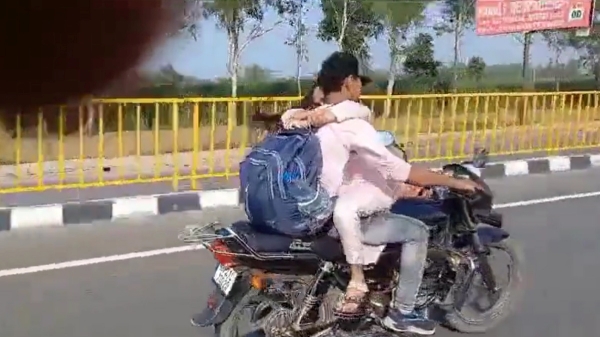 Young Couple hug each other while riding bike in Uttar Pradesh 