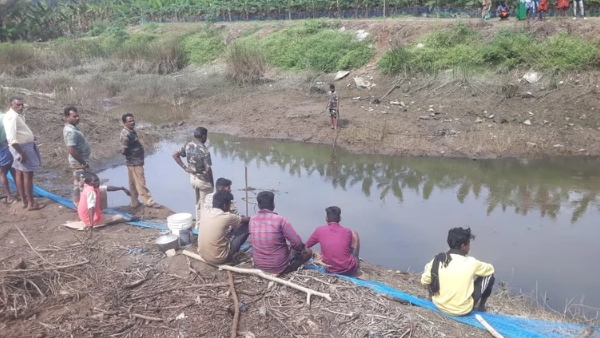 crocodile lying in the puddle missing forest department searching for it by draining the water 