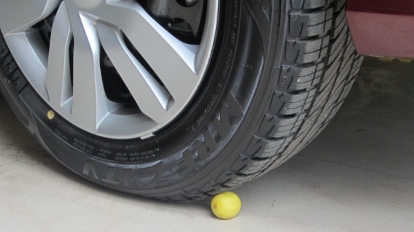 What is the reason behind crushing lemons under the tires of your car