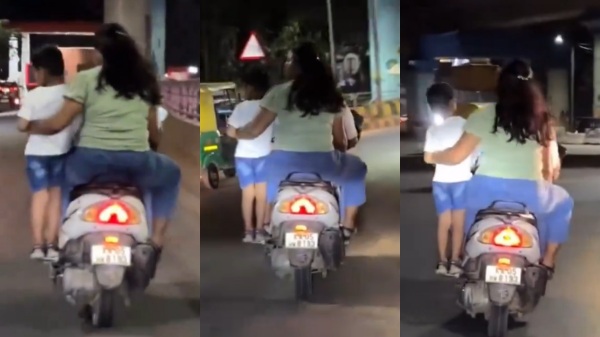 Couple travel in bike with their child dangerously standing on the foot rest of schooter Couple travel in bike with their child dangerously standing on the foot rest of schooter