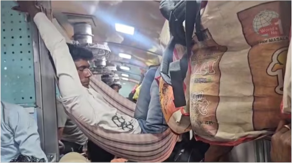 Brahmaputra Mail Passenger sleeps in makeshift hammock in overcrowded train