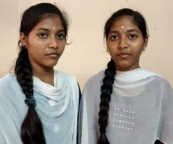 Two twin sisters have scored same marks in the 10th examination result Two twin sisters have scored same marks in the 10th examination result