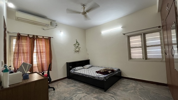 A woman explains the heat of Bangalore city by showing the AC installed in her bedroom