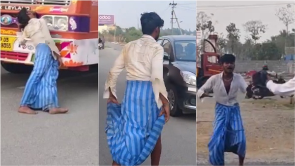 A drunkard sleeps while leaning on lorry Tamil Nadu - Karnataka border near krishnagiri