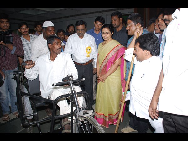 ట్రైసైకిల్ పంపిణీ చేస్తూ...