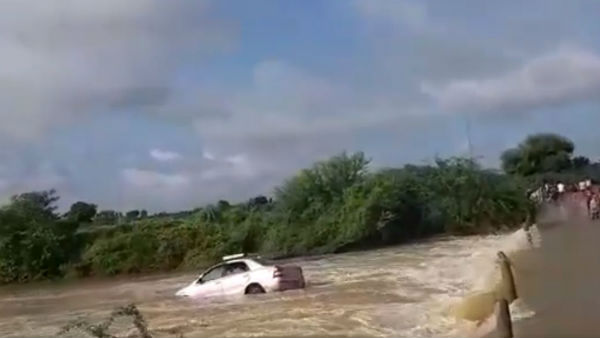 A car washed away in stream near Gooty in Ananthapur district as narrow escape for two people A car washed away in stream near Gooty in Ananthapur district as narrow escape for two people