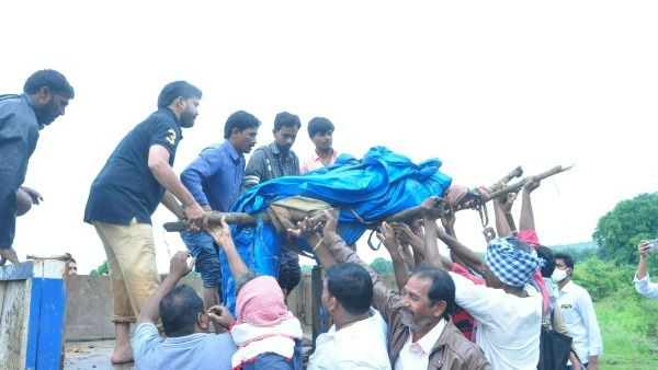 mla methuku anand carries body of a newly wed bride who washed away in flooded stream