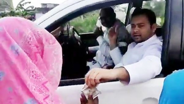 Video viral: Tejashwi Yadav distributing cash among women, JDU leader says give back their land Video viral: Tejashwi Yadav distributing cash among women, JDU leader says give back their land