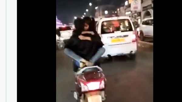 In Rajasthan, a video of a girl and a boy sitting opposite each other on a bike and having a romance is going viral on social media