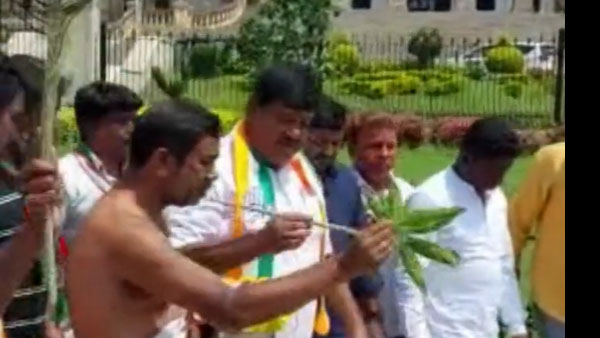 Congress workers sprinkle cow urine and perform Pooja at the State Assembly