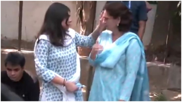 Rahul Priyanka Gandhi Vadra and her children wait outside a polling booth in Delhi