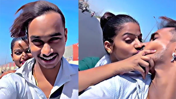Viral Video Lovers lip lock while riding a bike Netizens are on fire