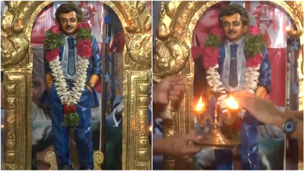 A fan performing abhishekam in Sri Rajini Temple