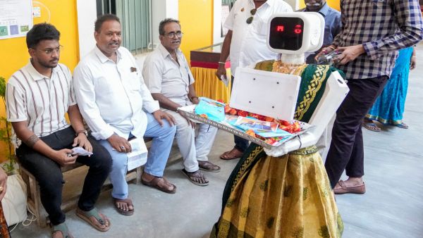 Meet Neela The Humanoid Robot Welcoming Voters With Roses at Puducherry Assembly Election Polling Booths Meet Neela The Humanoid Robot Welcoming Voters With Roses at Puducherry Assembly Election Polling Booths