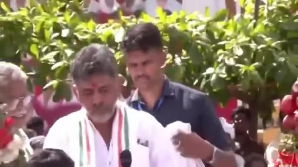 karnataka-chief-minister-dk-shivakumar-faces-criticism-after-tossing-bitten-apples-to-supporters