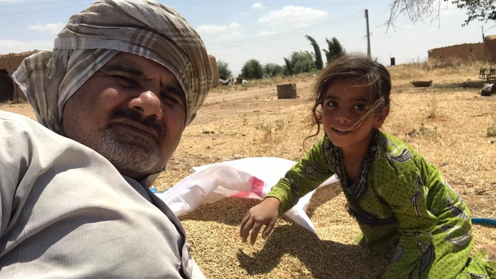 Abood Hamam and a girl with some harvested barley Abood Hamam and a girl with some harvested barley