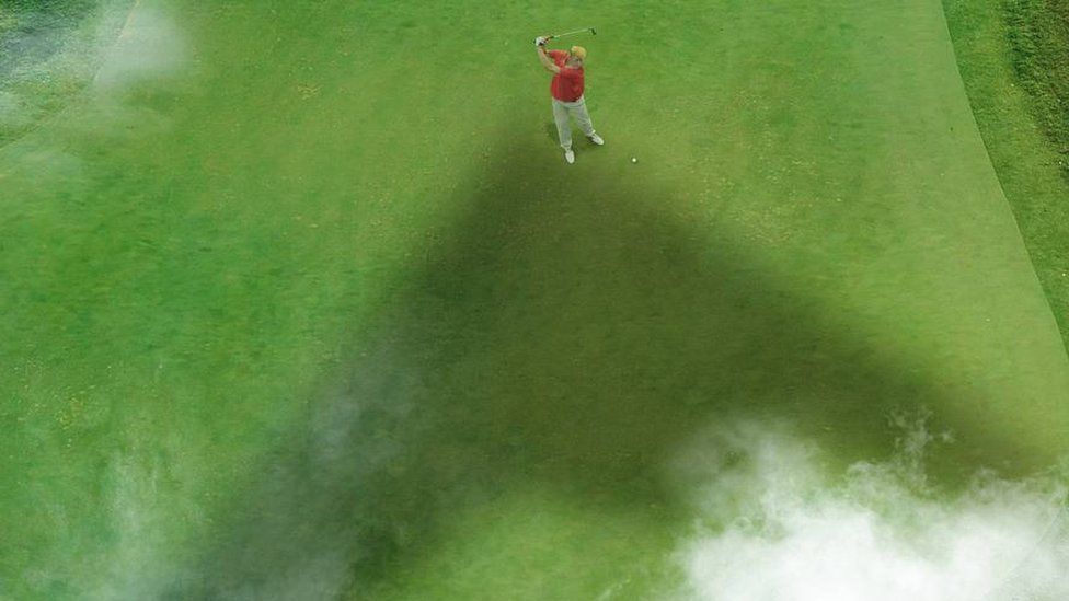 యుద్ధవిమానం నీడలో గోల్ఫ్ ఆడుతున్న ట్రంప్ యుద్ధవిమానం నీడలో గోల్ఫ్ ఆడుతున్న ట్రంప్